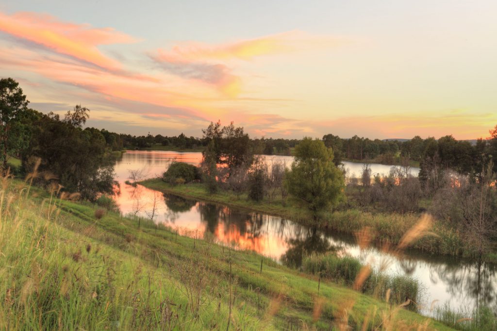 A beautiful sunset over Penrith Lakes Wetlands near Castlereagh with Blue Mountains in distance. The area was one of the first rural settlements in Australia and is one of the five Macquarie towns